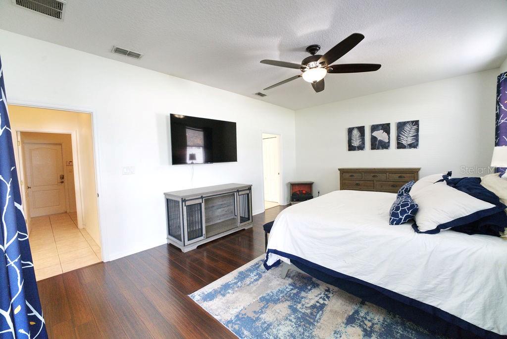 2309 Wolf Ridge Lane Mount Dora, FL 32757 - Photo 37 of 62 a bedroom with a bed and a flat screen tv