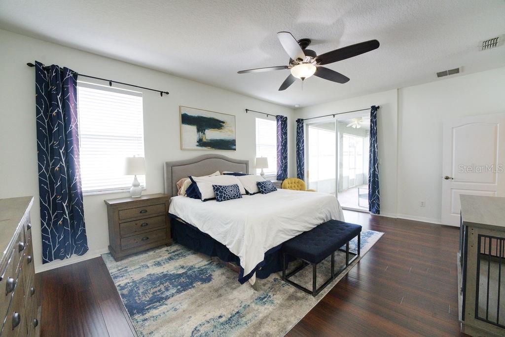 2309 Wolf Ridge Lane Mount Dora, FL 32757 - Photo 40 of 62 a spacious bedroom with a bed and a window