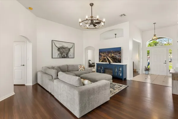 a living room with furniture and a chandelier