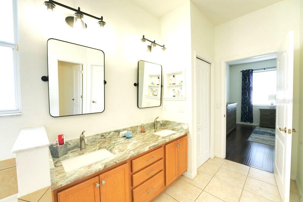 2309 Wolf Ridge Lane Mount Dora, FL 32757 - Photo 41 of 62 a bathroom with a granite countertop sink and a mirror