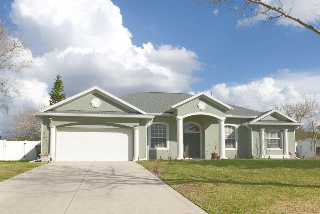 2309 Wolf Ridge Lane Mount Dora, FL 32757 - Photo 60 of 62 a view of a big house with a big yard and large trees