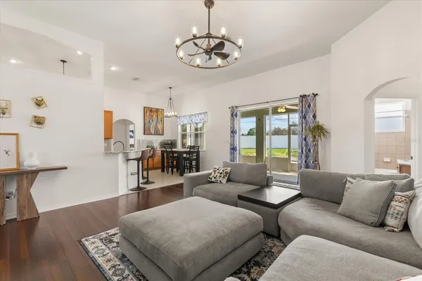 a living room with furniture and a chandelier