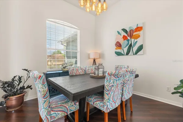 a view of a dining room with furniture and wooden floor
