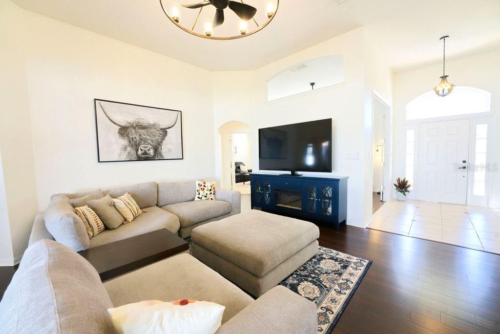 2309 Wolf Ridge Lane Mount Dora, FL 32757 - Photo 10 of 62 a living room with furniture and a flat screen tv