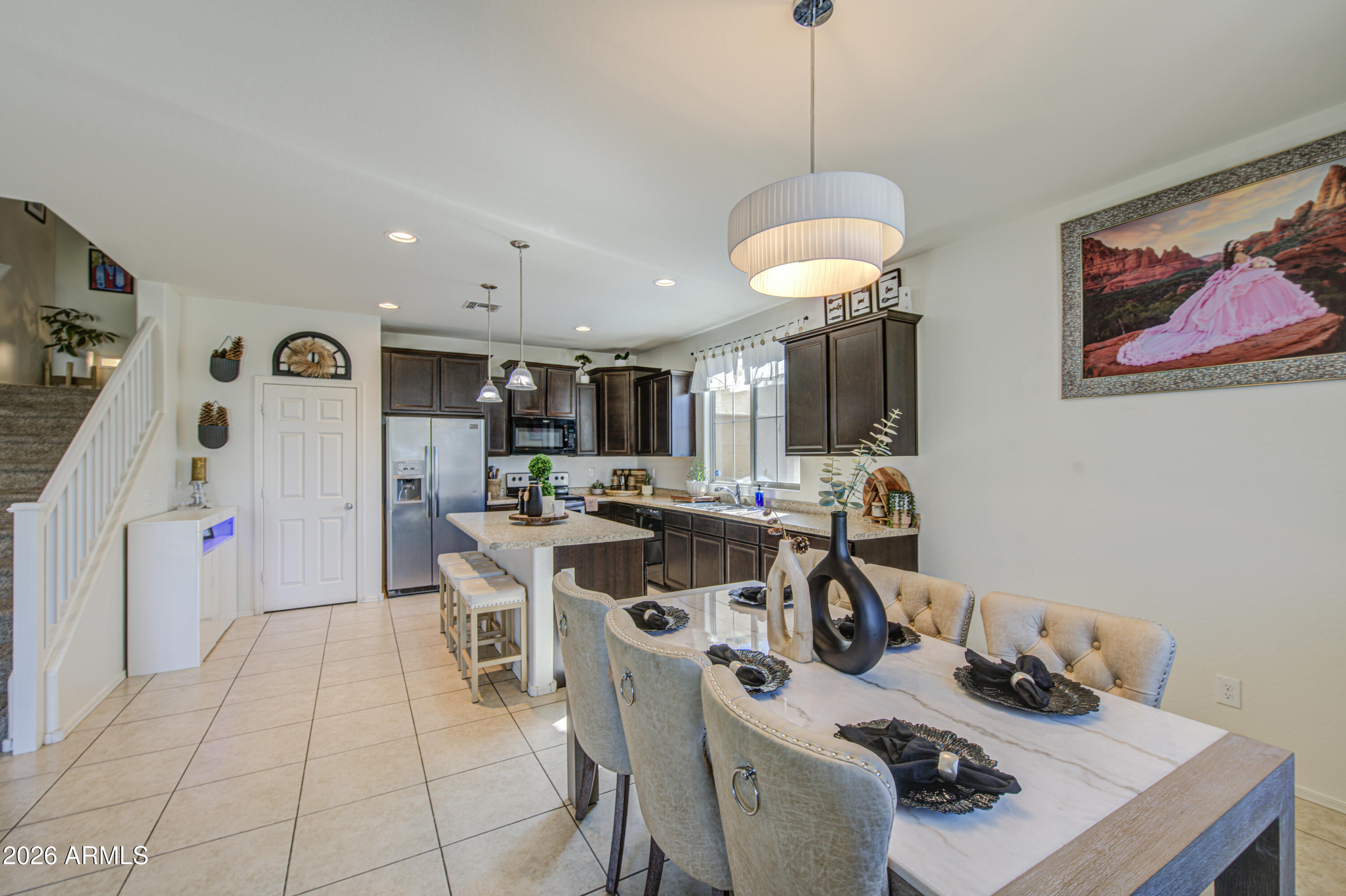 12202 West Del Rio Lane Avondale, AZ 85323 - Photo 13 of 49 a view of a dining room with furniture and a chandelier