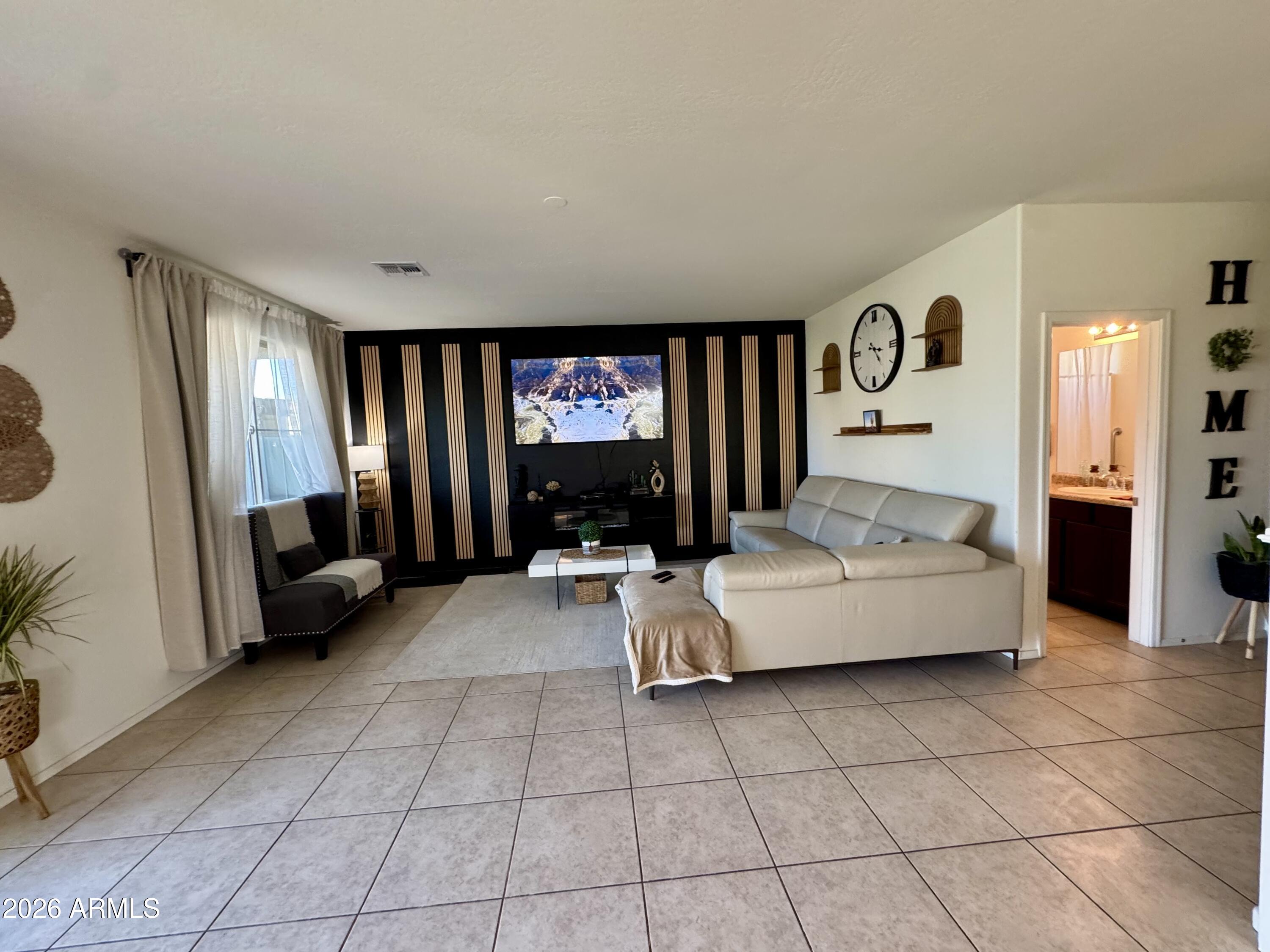 12202 West Del Rio Lane Avondale, AZ 85323 - Photo 16 of 60 a living room with furniture and a flat screen tv
