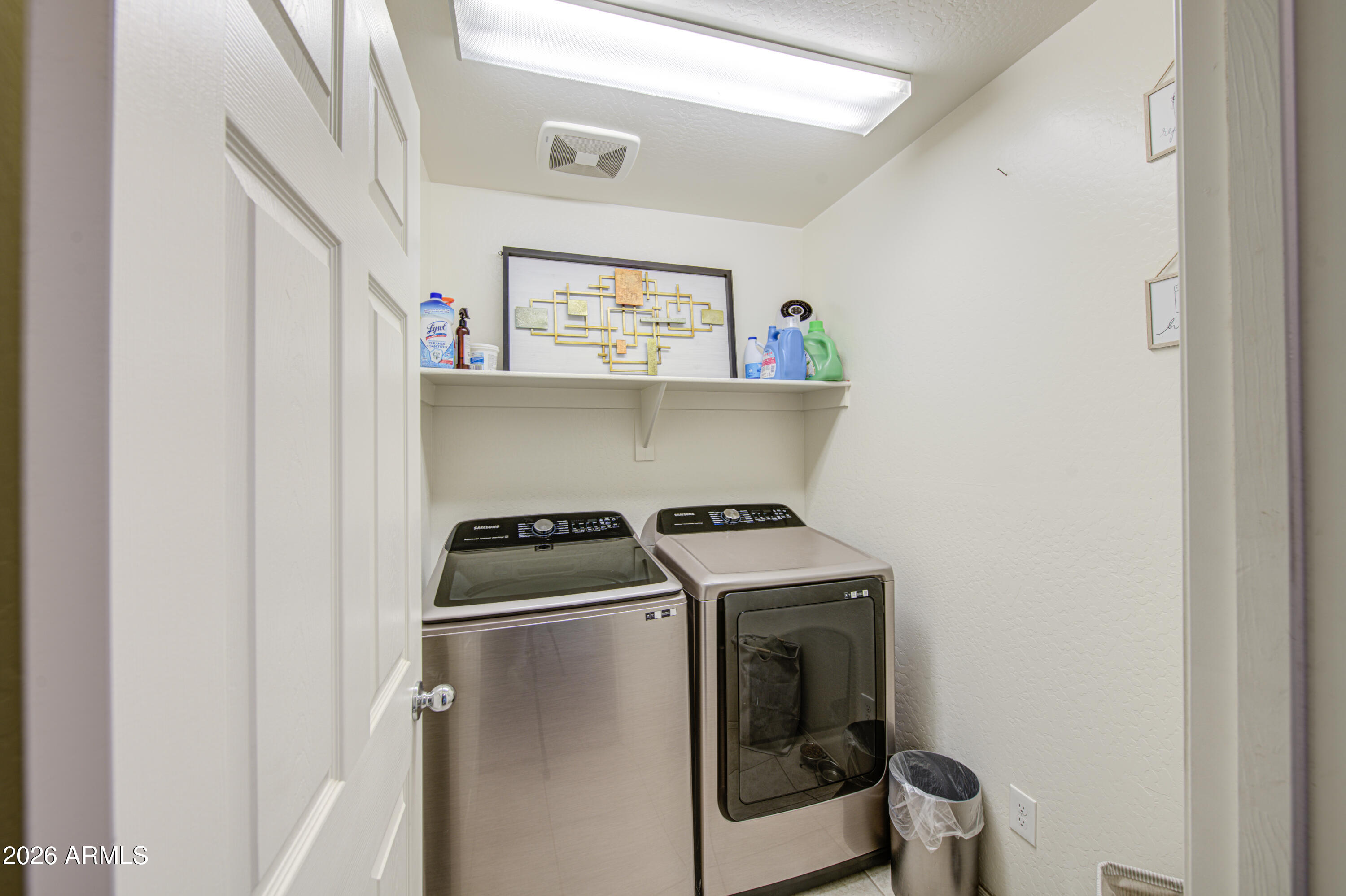 12202 West Del Rio Lane Avondale, AZ 85323 - Photo 17 of 49 a utility room with dryer washer and a view of living room