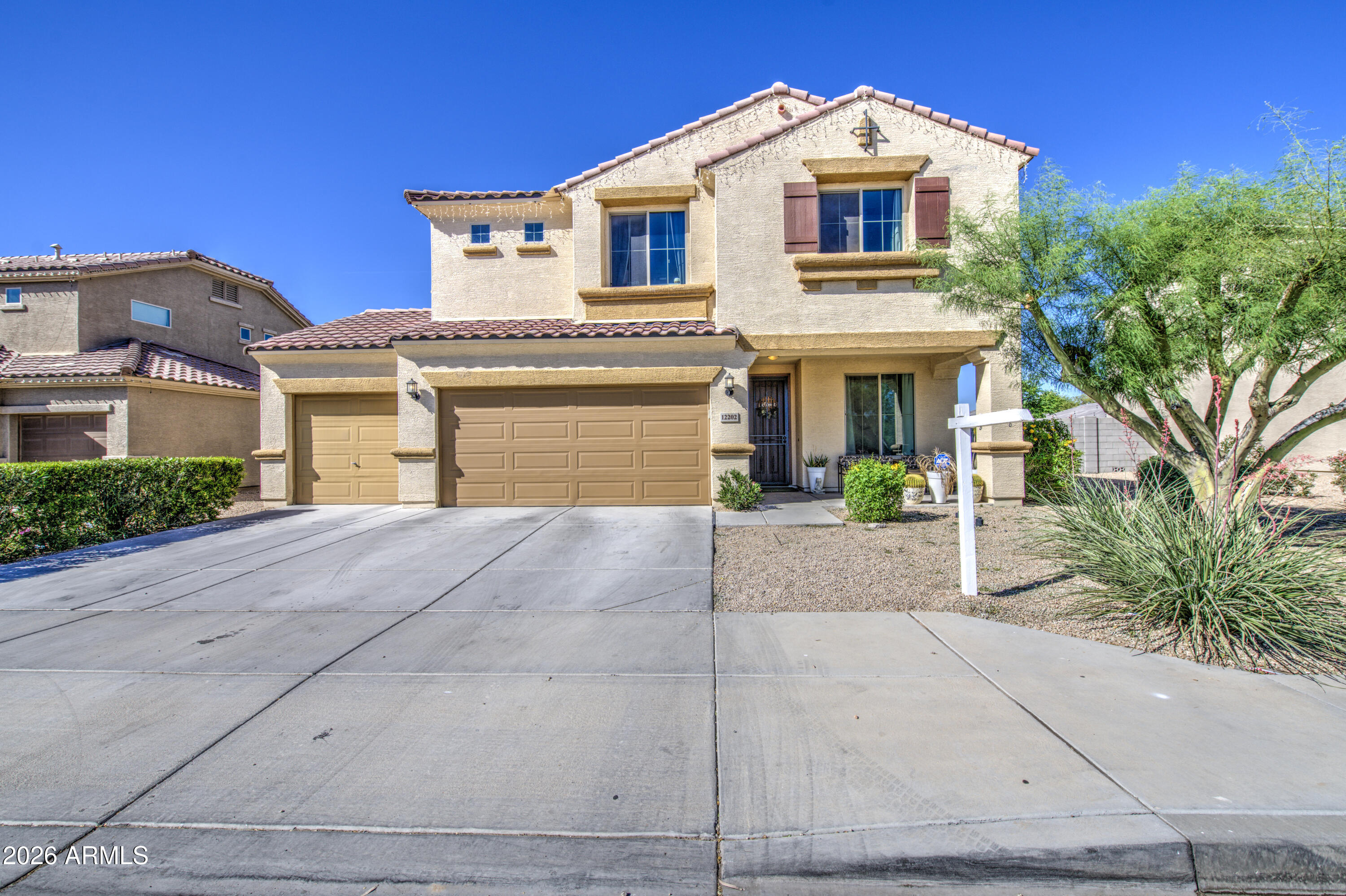 12202 West Del Rio Lane Avondale, AZ 85323 - Photo 2 of 49 a front view of a house with a yard and garage