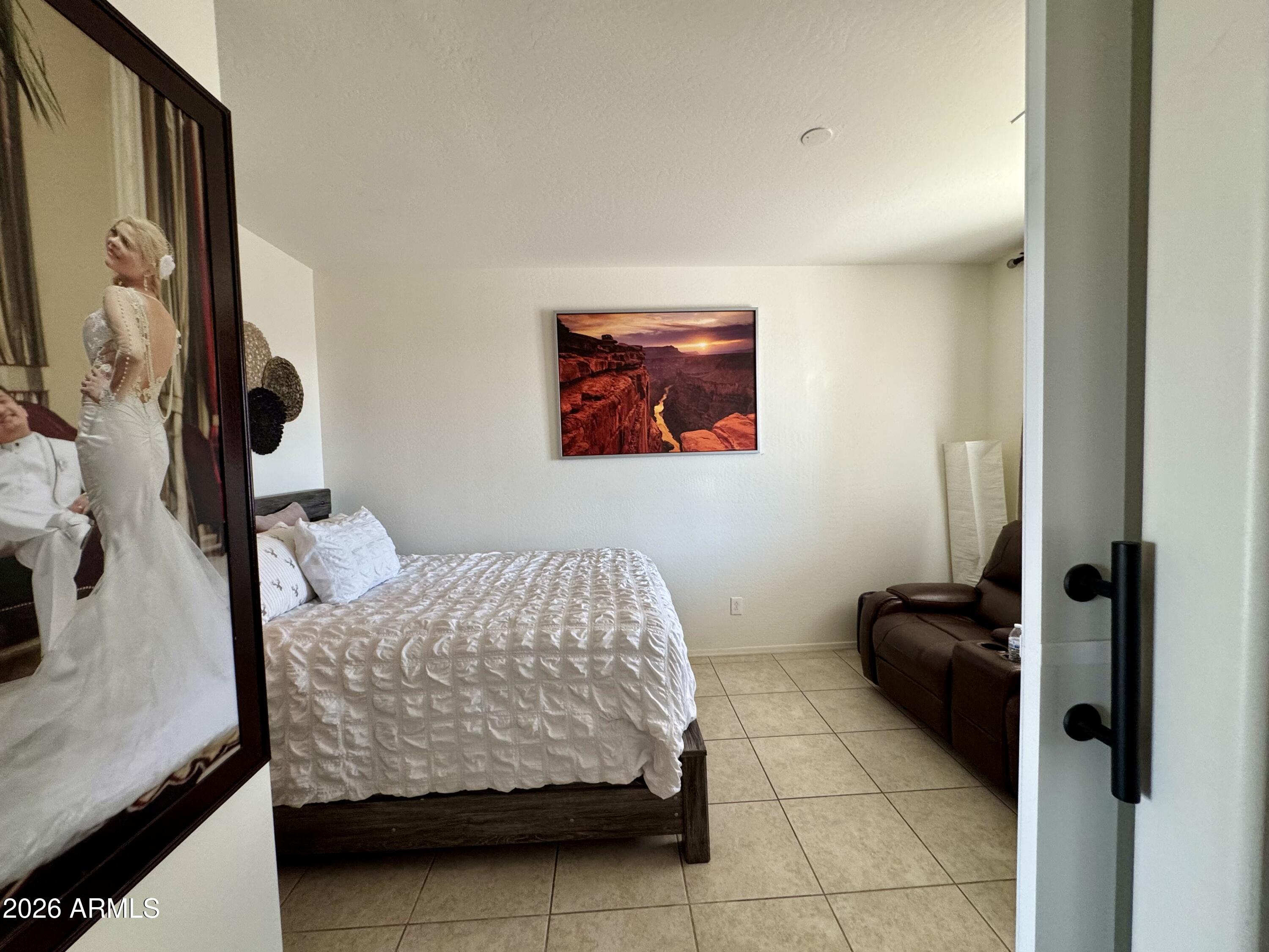 12202 West Del Rio Lane Avondale, AZ 85323 - Photo 22 of 60 a bedroom with a bed and flat screen tv