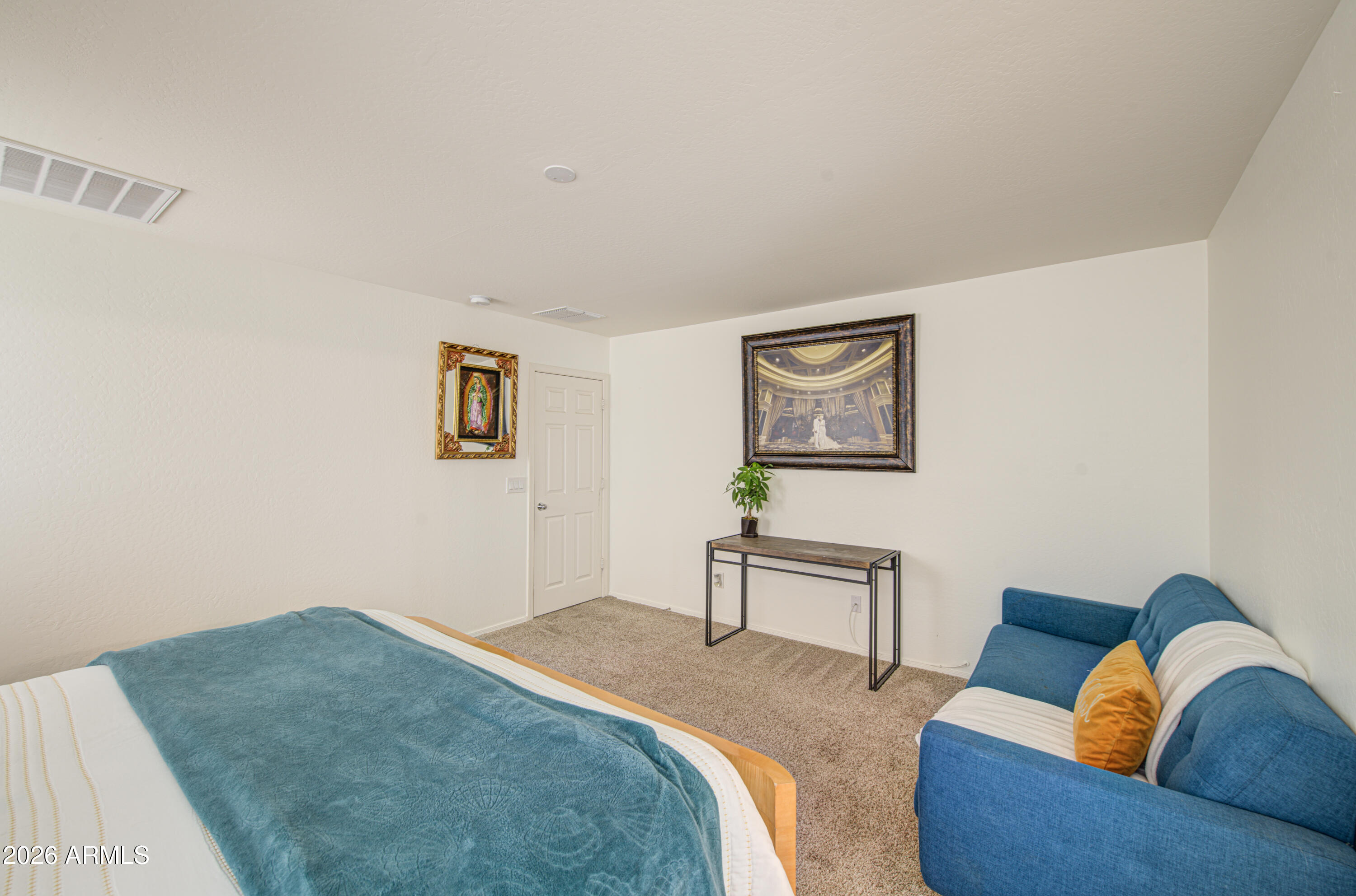 12202 West Del Rio Lane Avondale, AZ 85323 - Photo 26 of 49 a bedroom with furniture and a wooden floor