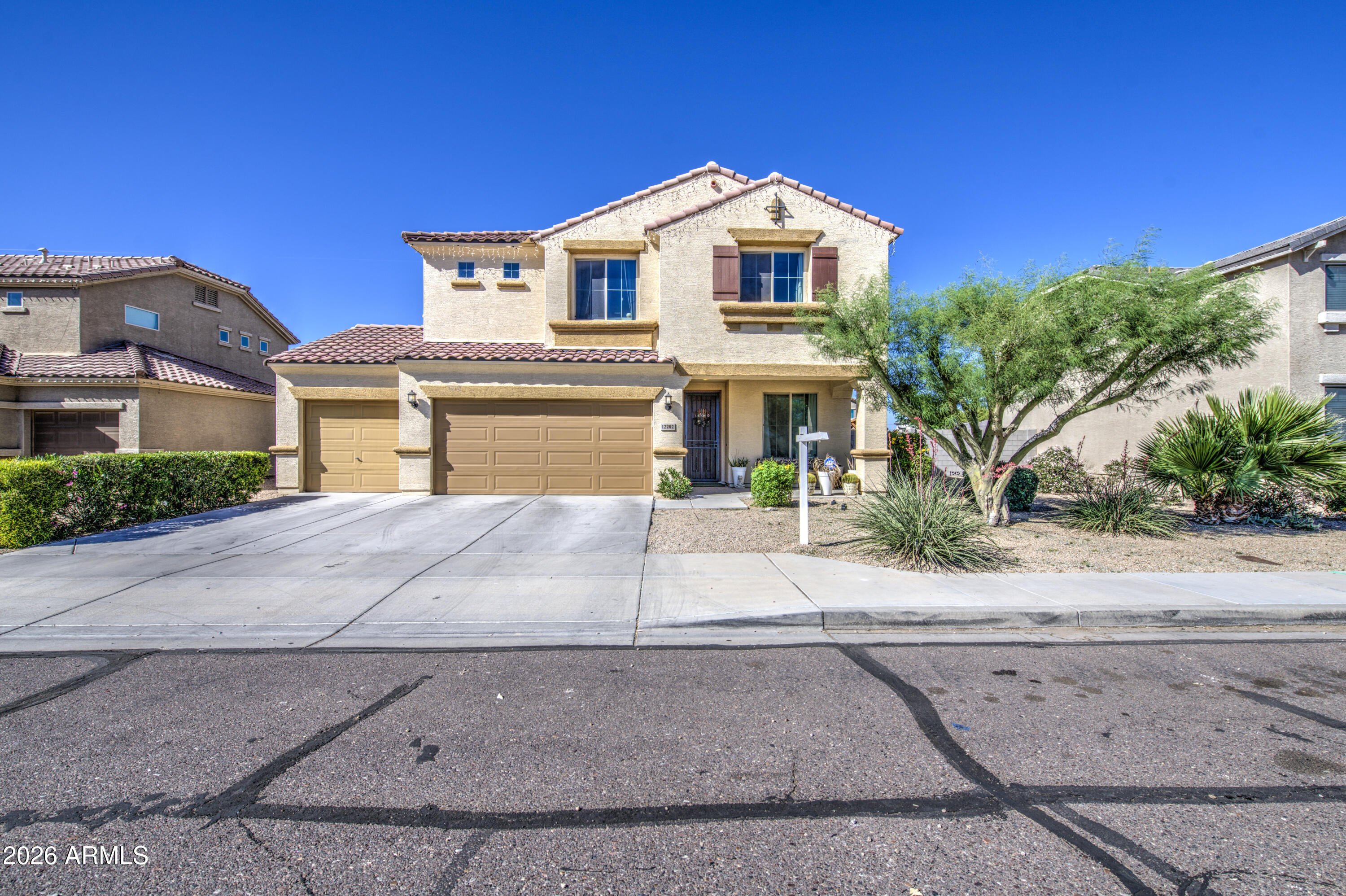 12202 West Del Rio Lane Avondale, AZ 85323 - Photo 3 of 49 a front view of a house with a yard