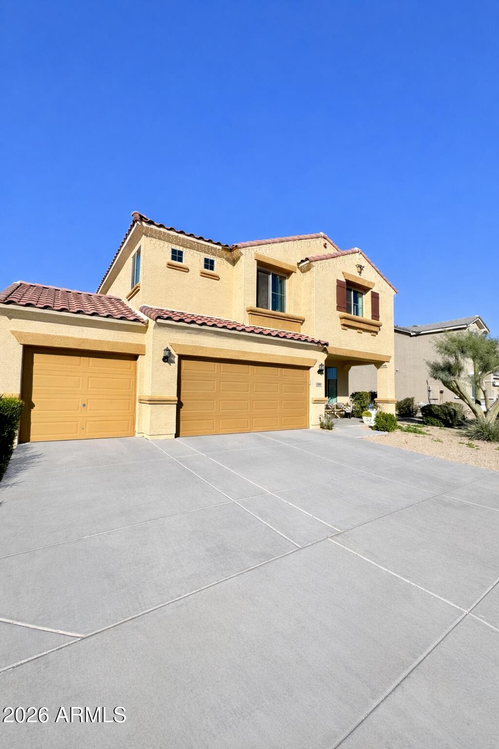 12202 West Del Rio Lane Avondale, AZ 85323 - Photo 3 of 60 a front view of a house with a yard