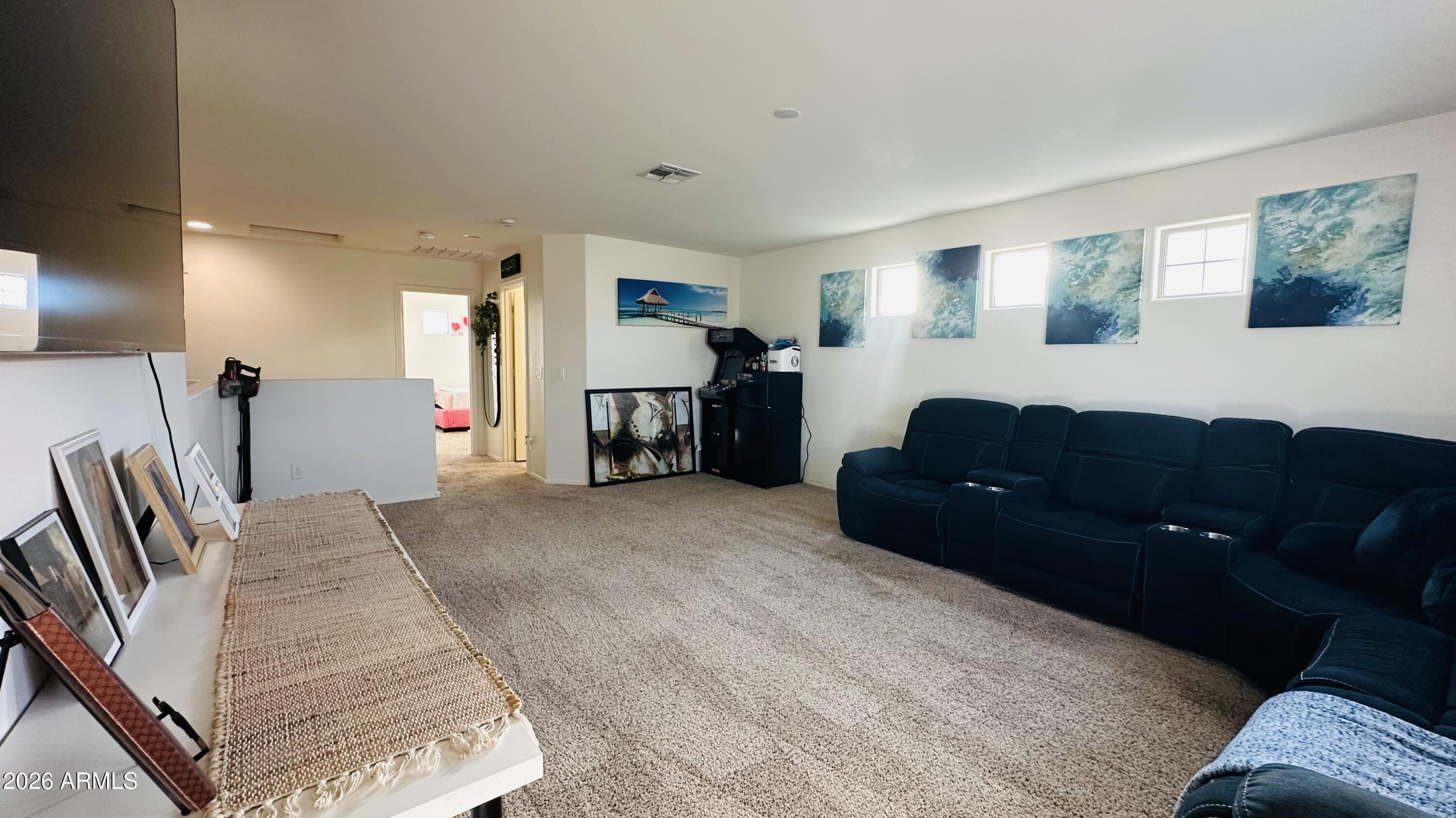 12202 West Del Rio Lane Avondale, AZ 85323 - Photo 31 of 60 a living room with furniture and a mirror
