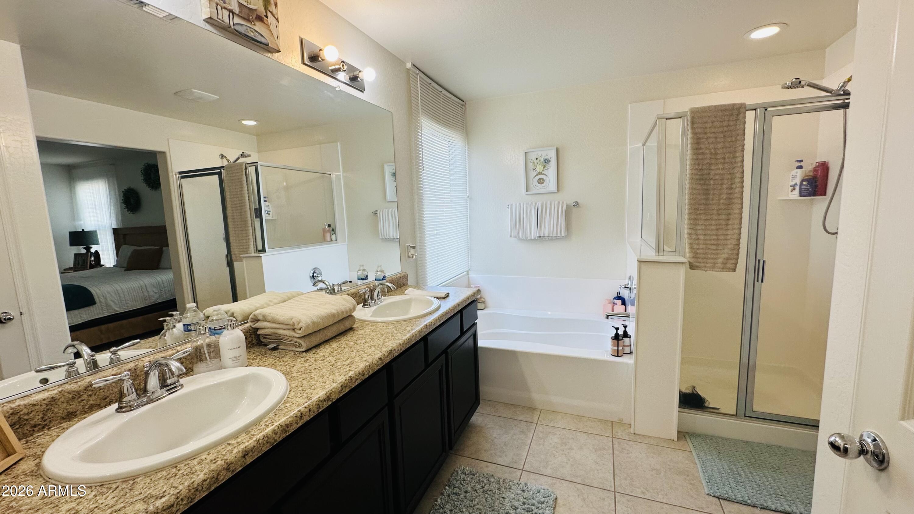 12202 West Del Rio Lane Avondale, AZ 85323 - Photo 36 of 60 a bathroom with a granite countertop double vanity sink a mirror and a shower