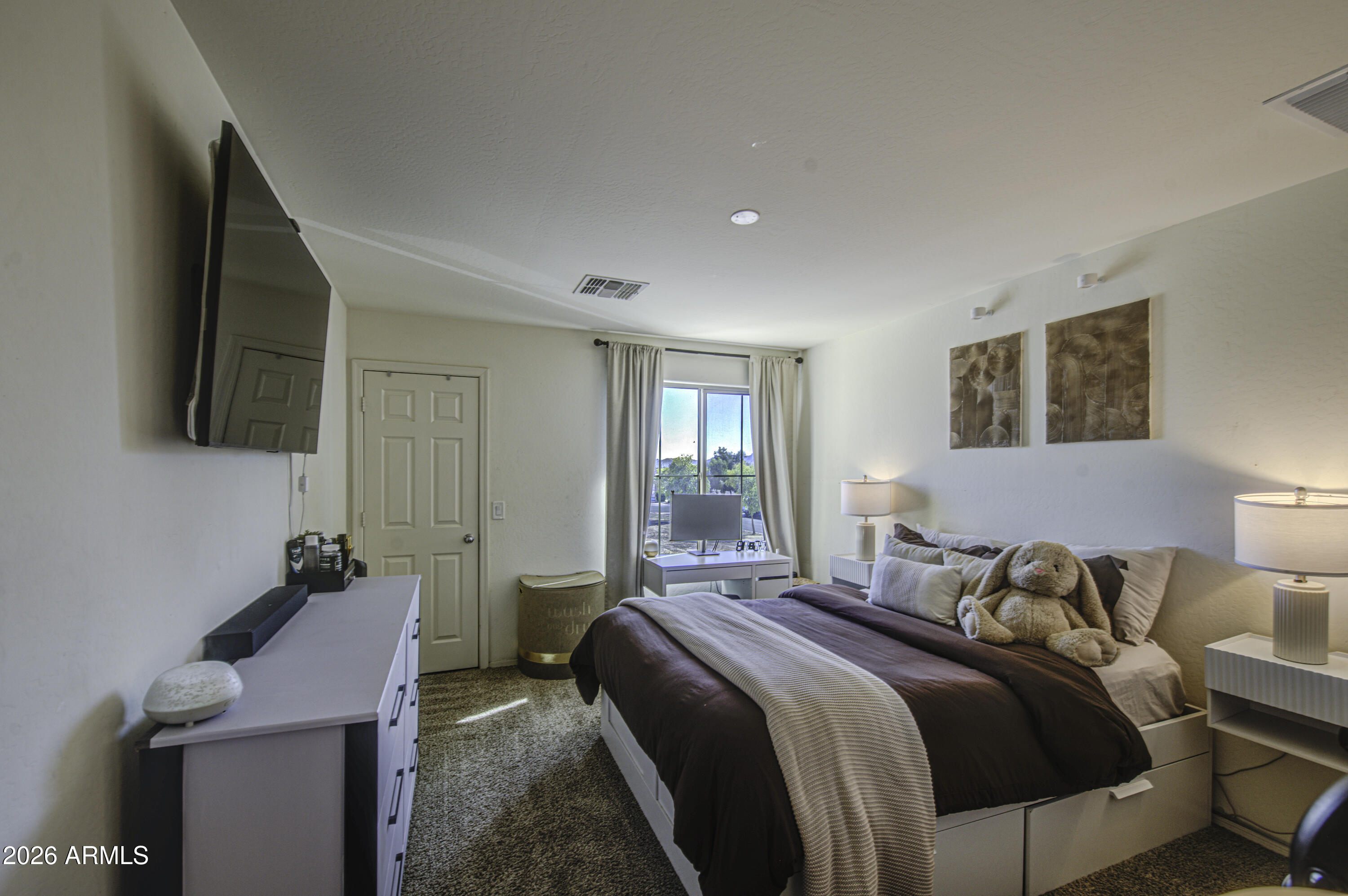 12202 West Del Rio Lane Avondale, AZ 85323 - Photo 36 of 49 a bedroom with a bed and a flat screen tv