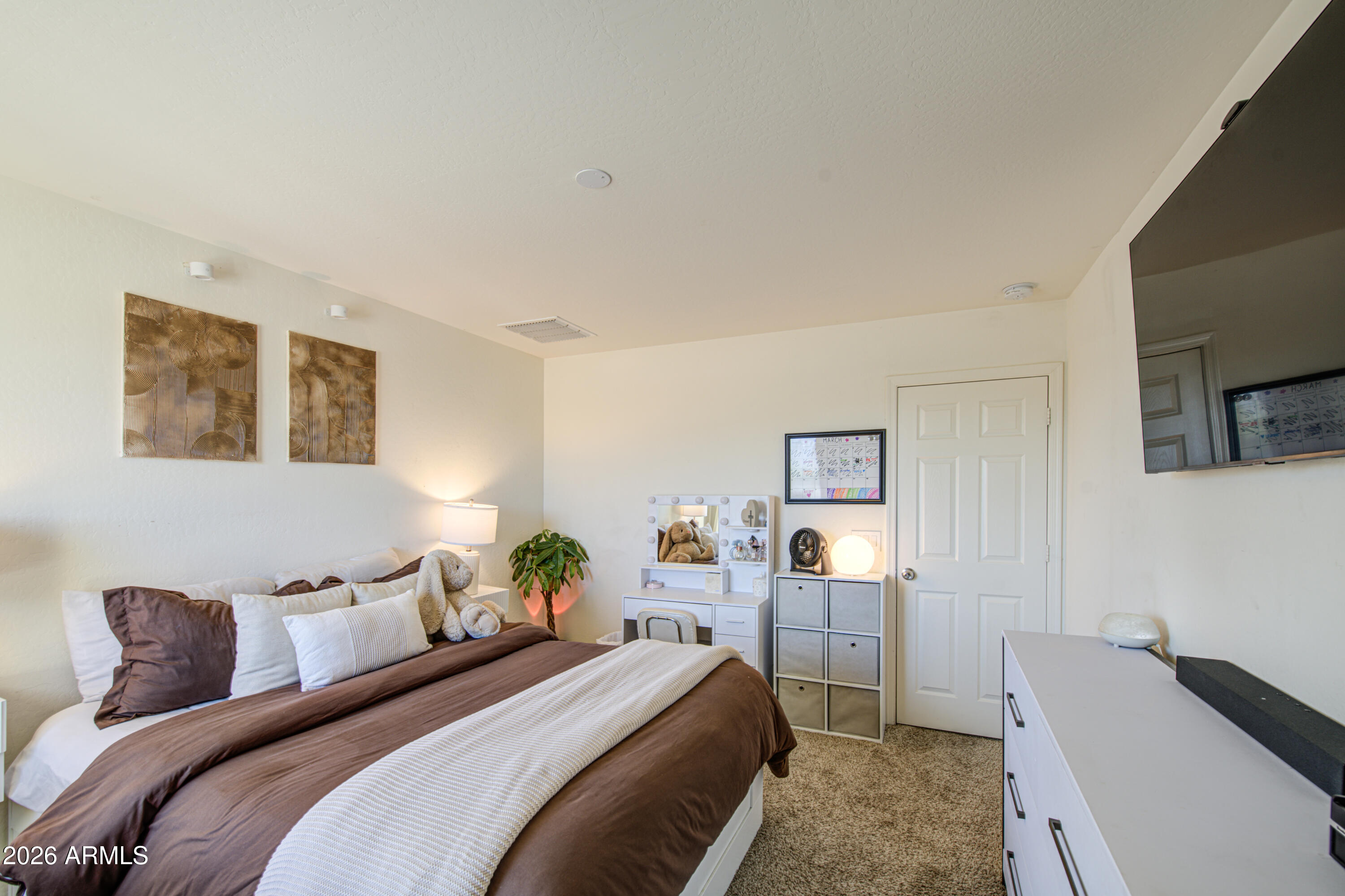 12202 West Del Rio Lane Avondale, AZ 85323 - Photo 37 of 49 a bedroom with a bed and a couch