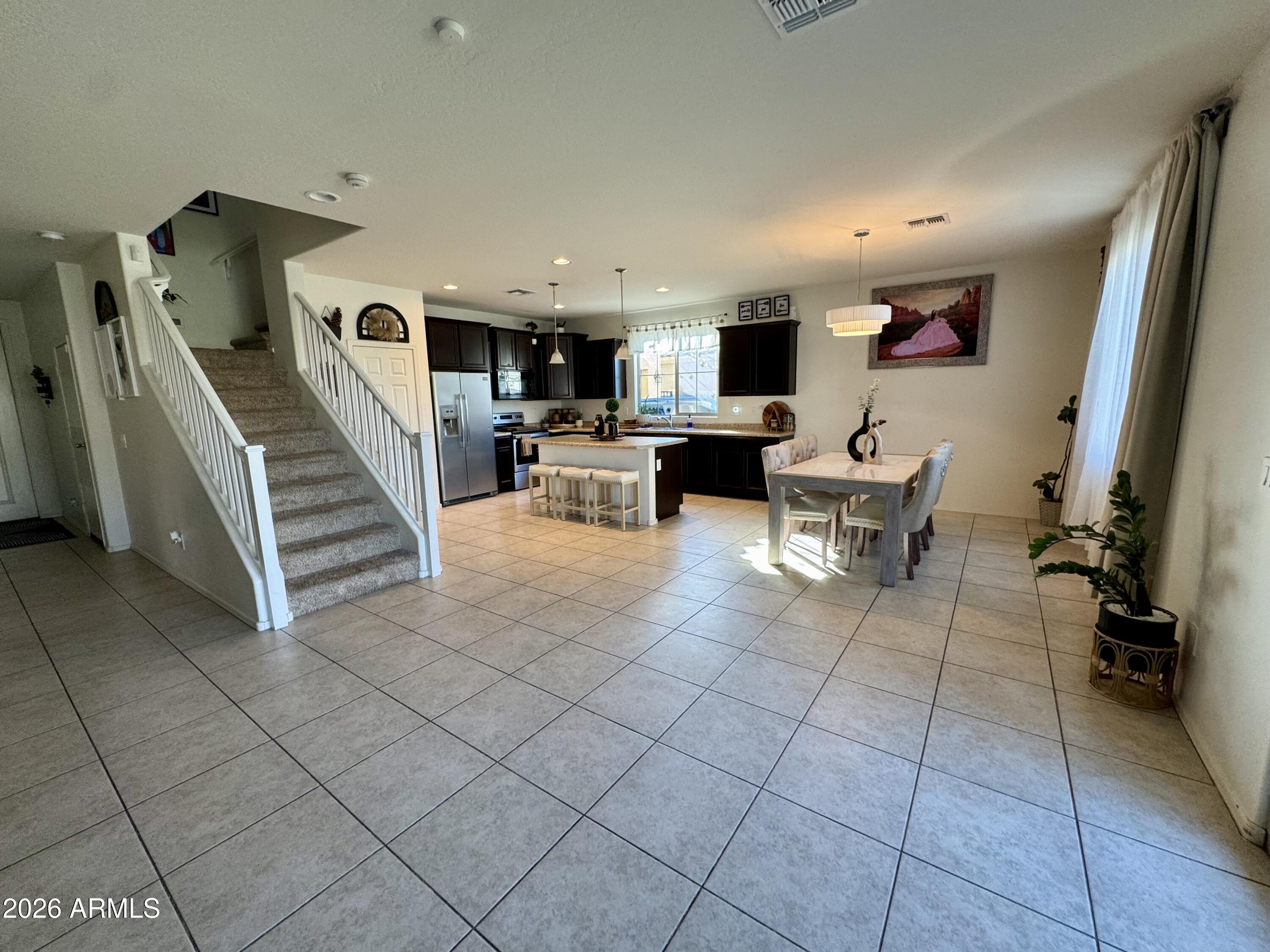 12202 West Del Rio Lane Avondale, AZ 85323 - Photo 4 of 60 a living room with furniture and a flat screen tv
