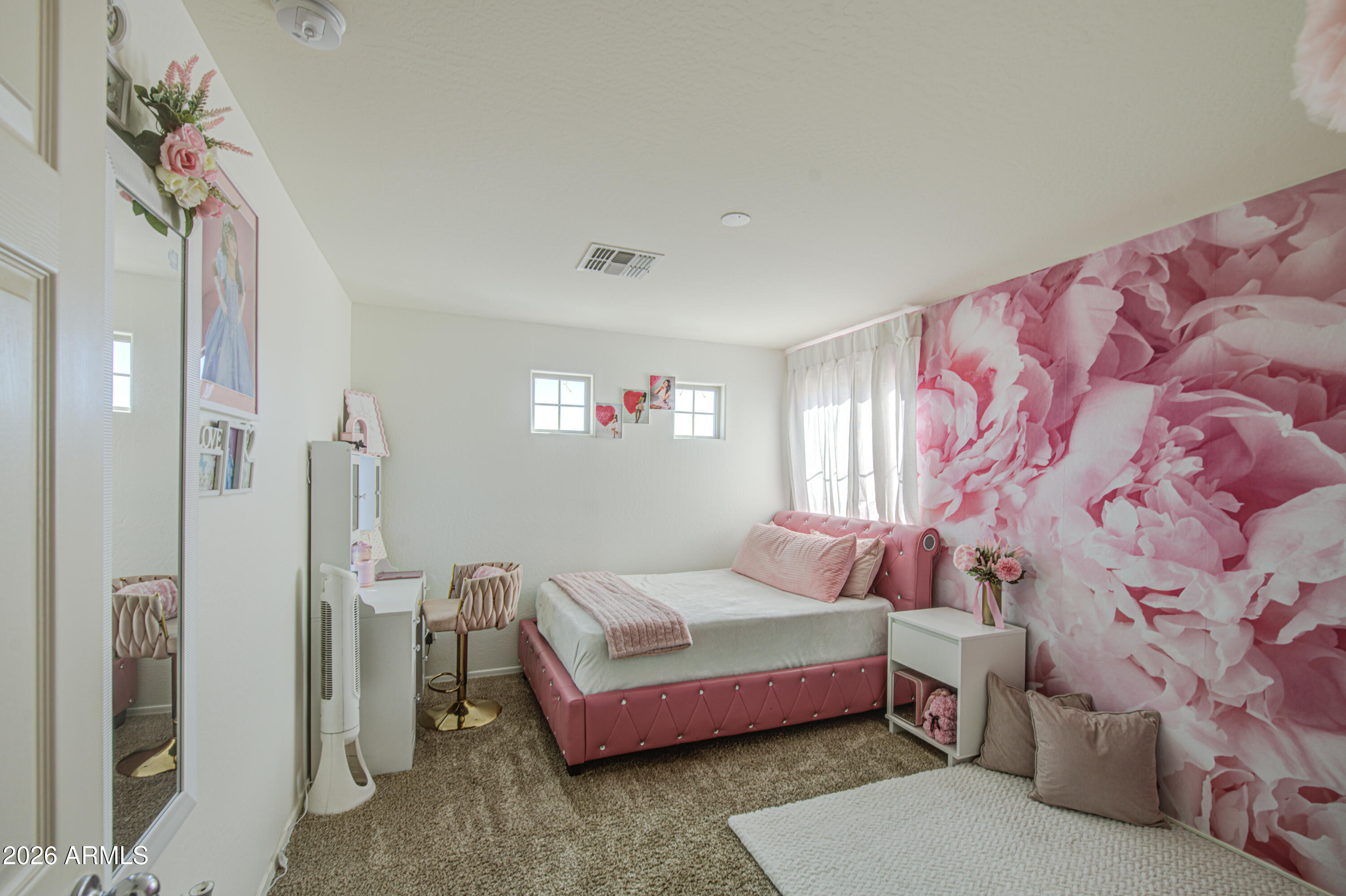 12202 West Del Rio Lane Avondale, AZ 85323 - Photo 41 of 49 a bedroom with a bed and a chandelier