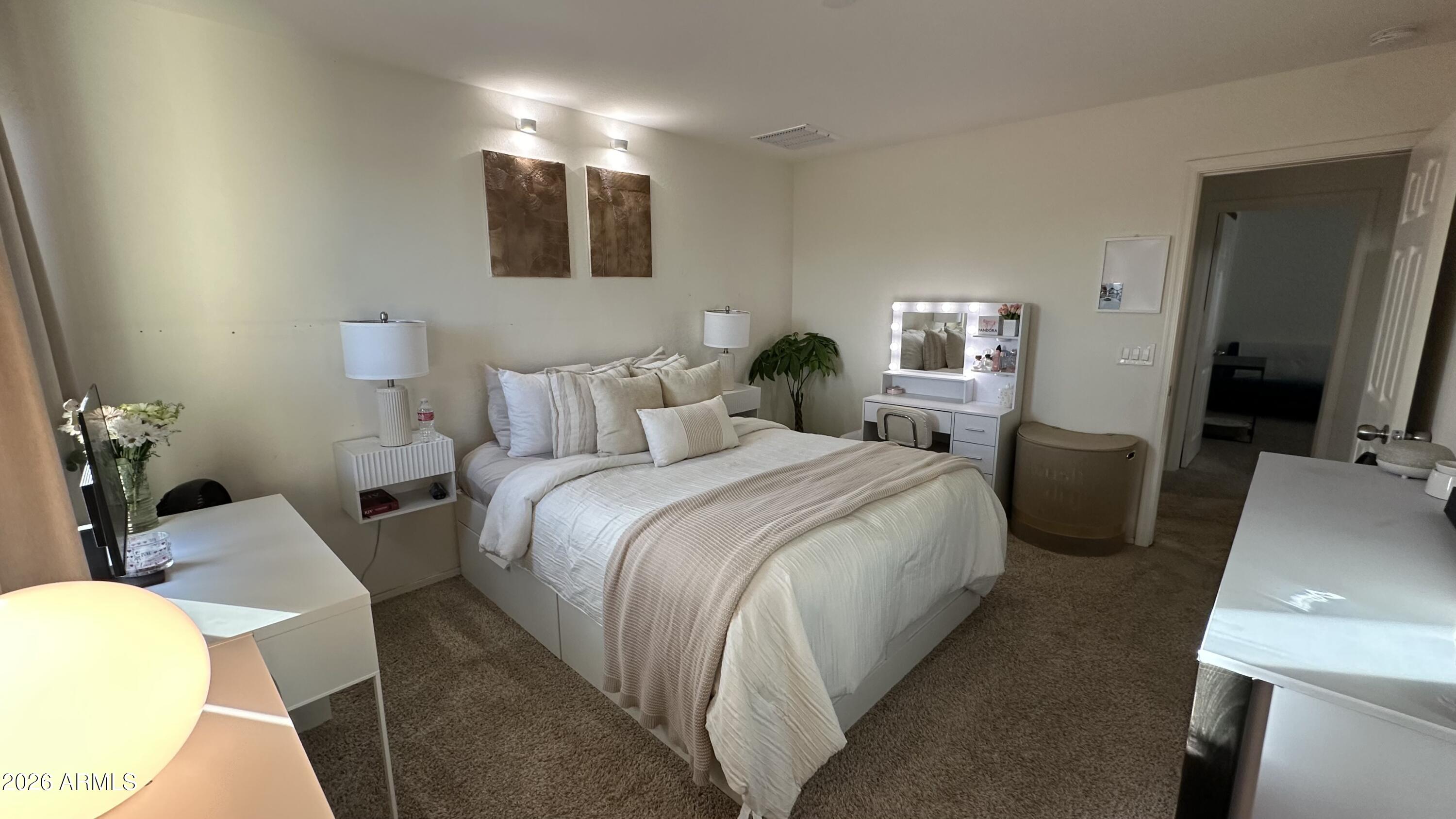 12202 West Del Rio Lane Avondale, AZ 85323 - Photo 50 of 60 a bedroom with a bed and a flat tv screen on a dresser