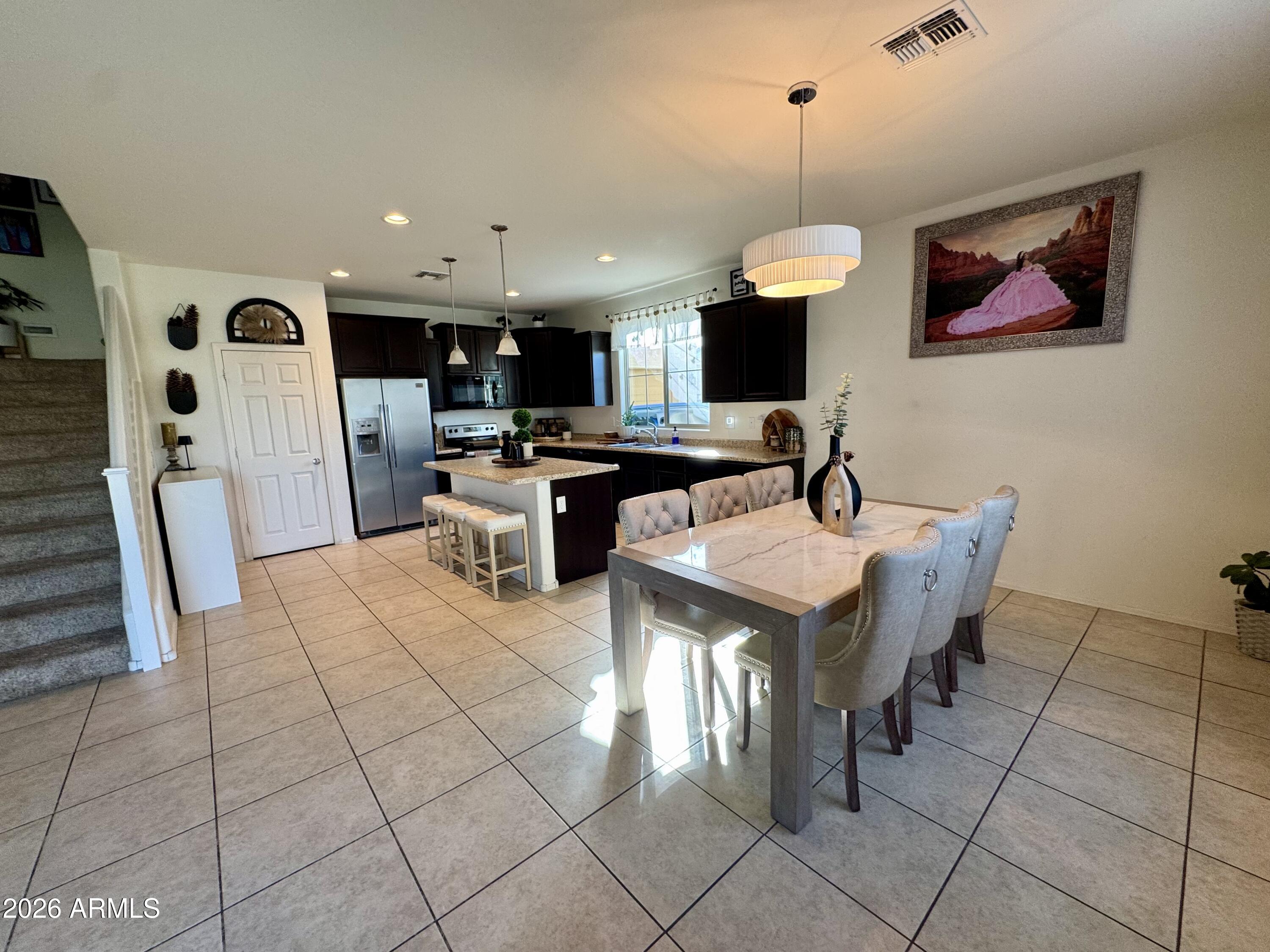 12202 West Del Rio Lane Avondale, AZ 85323 - Photo 5 of 60 a kitchen with stainless steel appliances granite countertop a sink a stove and a refrigerator