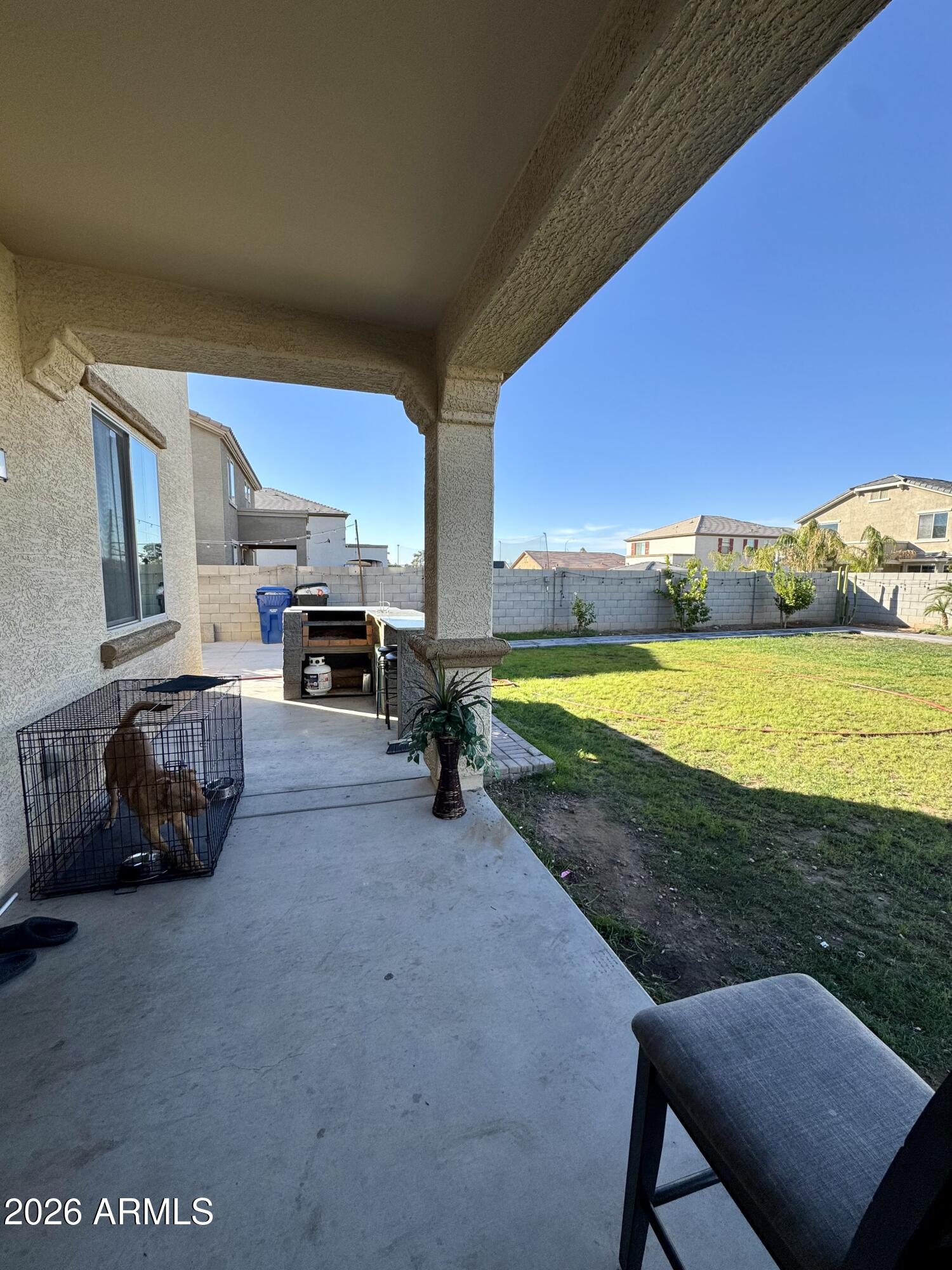 12202 West Del Rio Lane Avondale, AZ 85323 - Photo 58 of 60 a view of a backyard with table and chairs under an umbrella