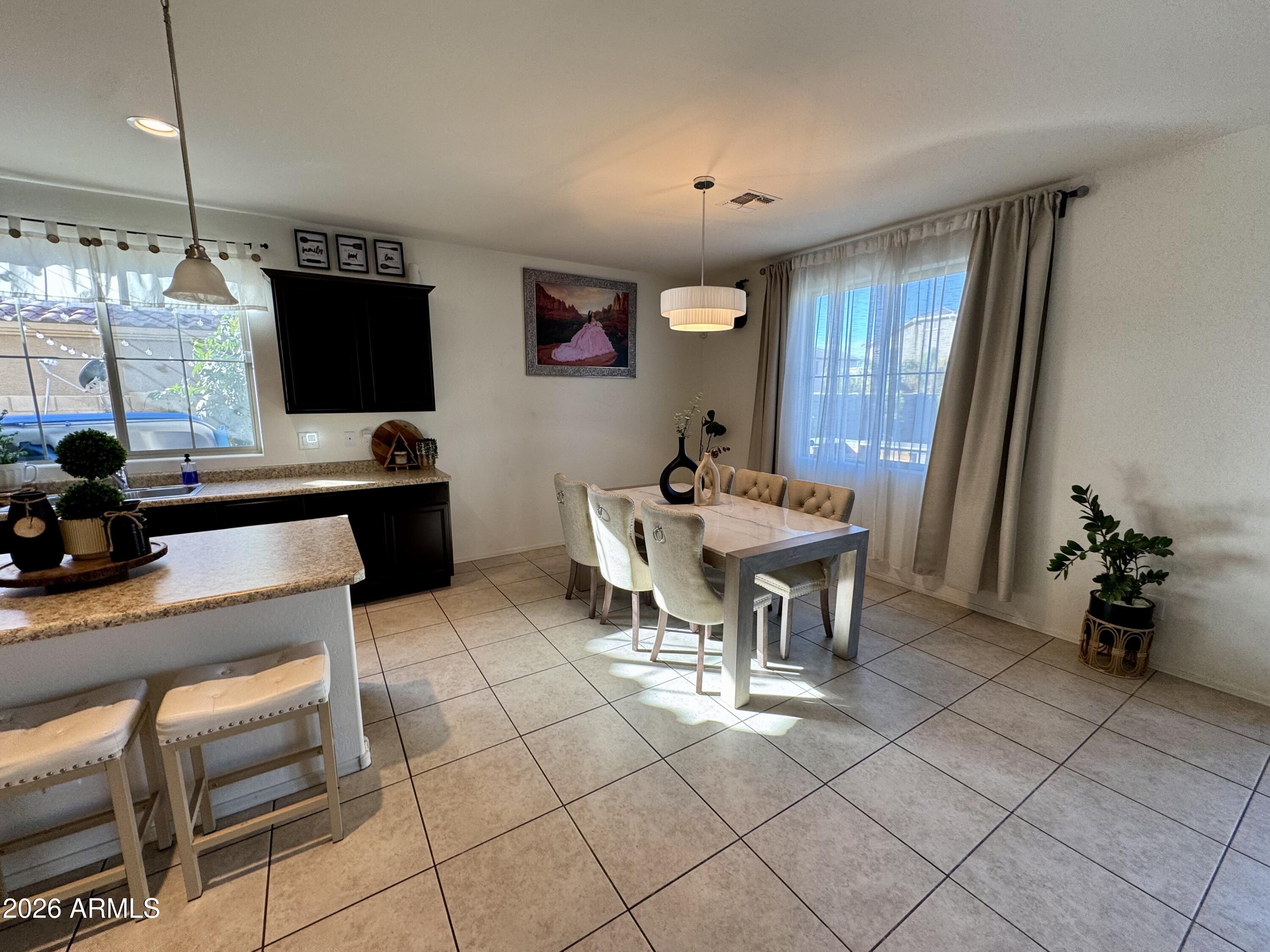 12202 West Del Rio Lane Avondale, AZ 85323 - Photo 7 of 60 a view of a dining room with furniture