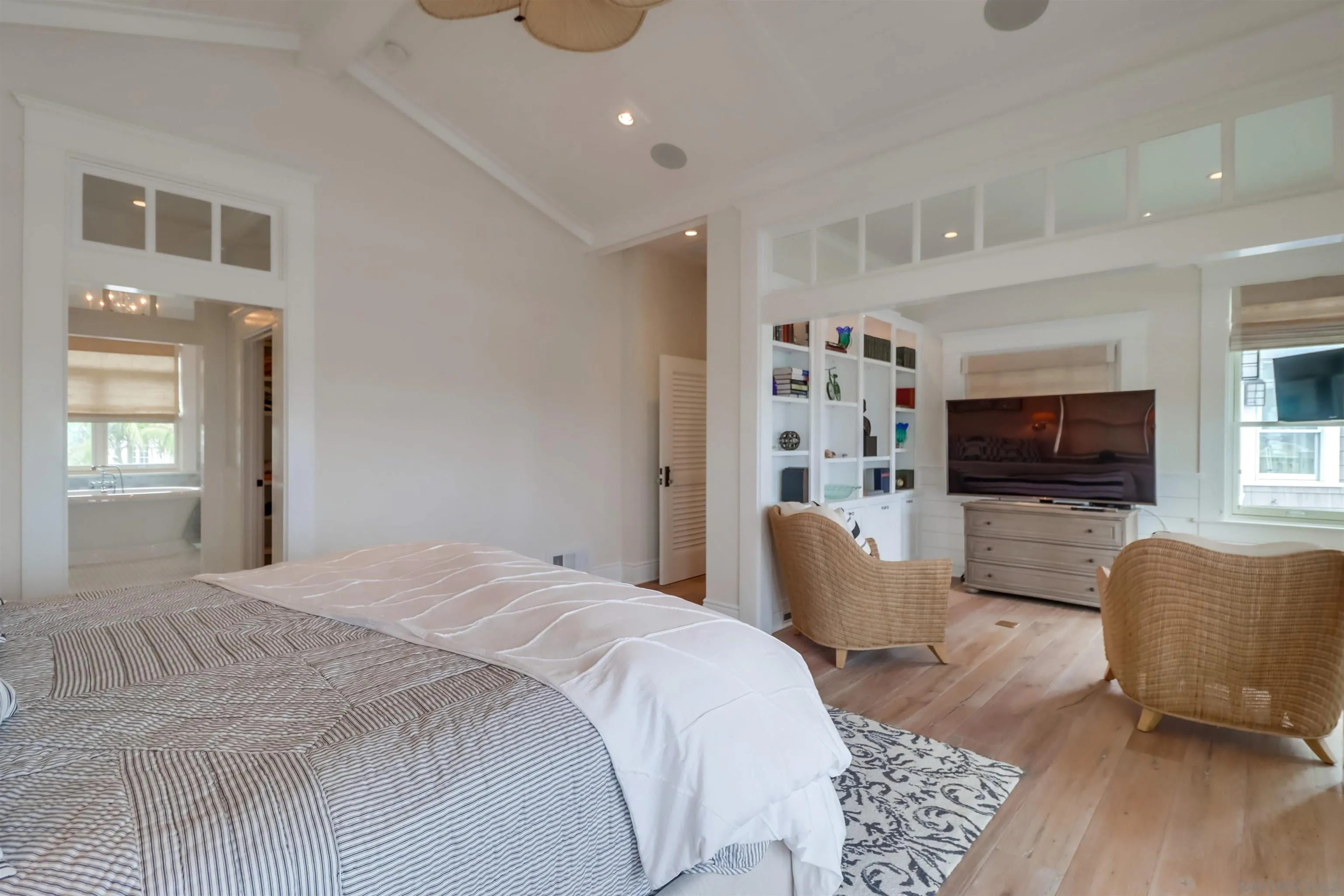 441 Ocean Boulevard Coronado, CA 92118 - Photo 15 of 40 a spacious bedroom with a bed a couch and a flat screen tv