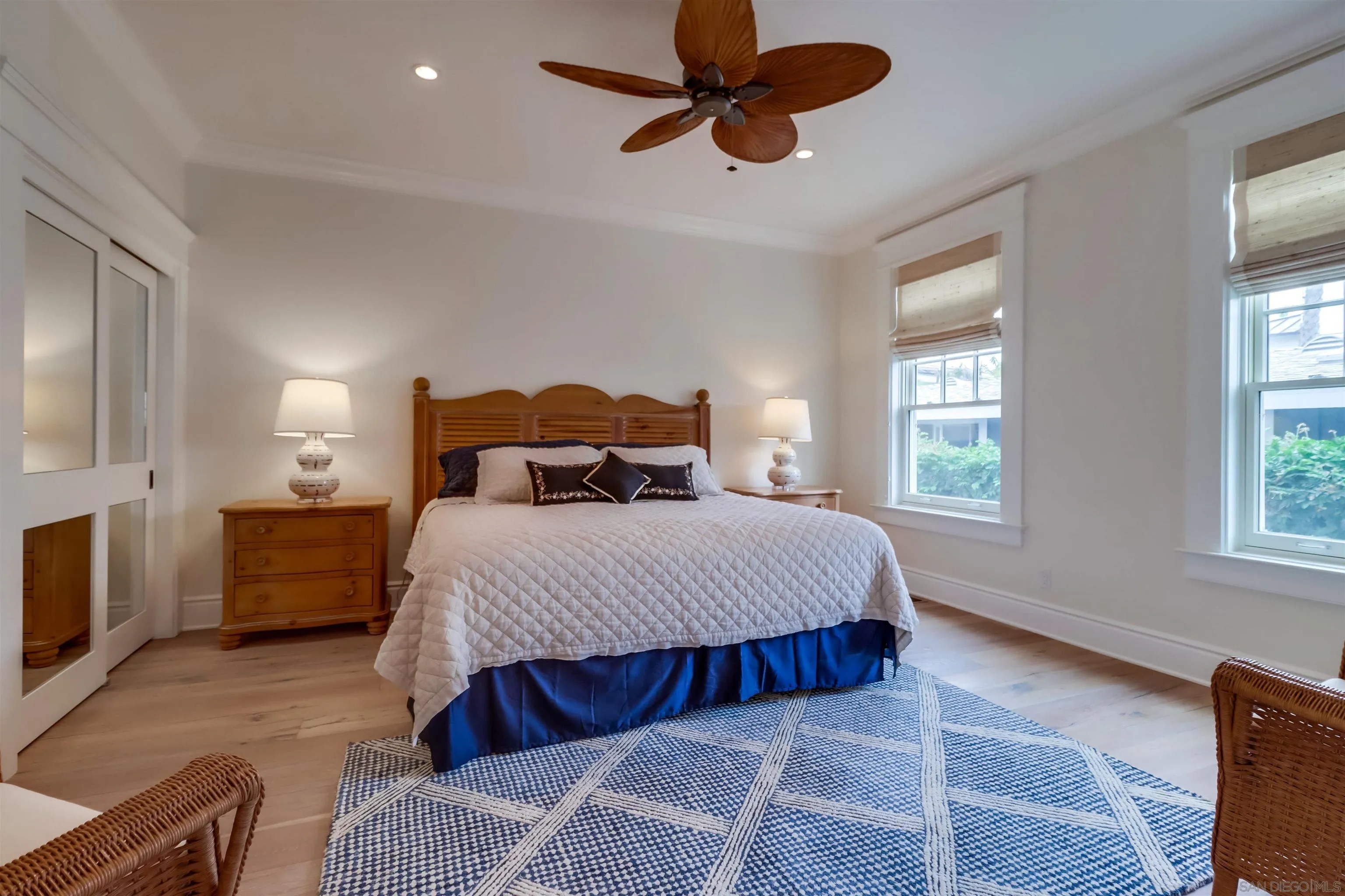 441 Ocean Boulevard Coronado, CA 92118 - Photo 22 of 40 a bedroom with a bed a chandelier and a window