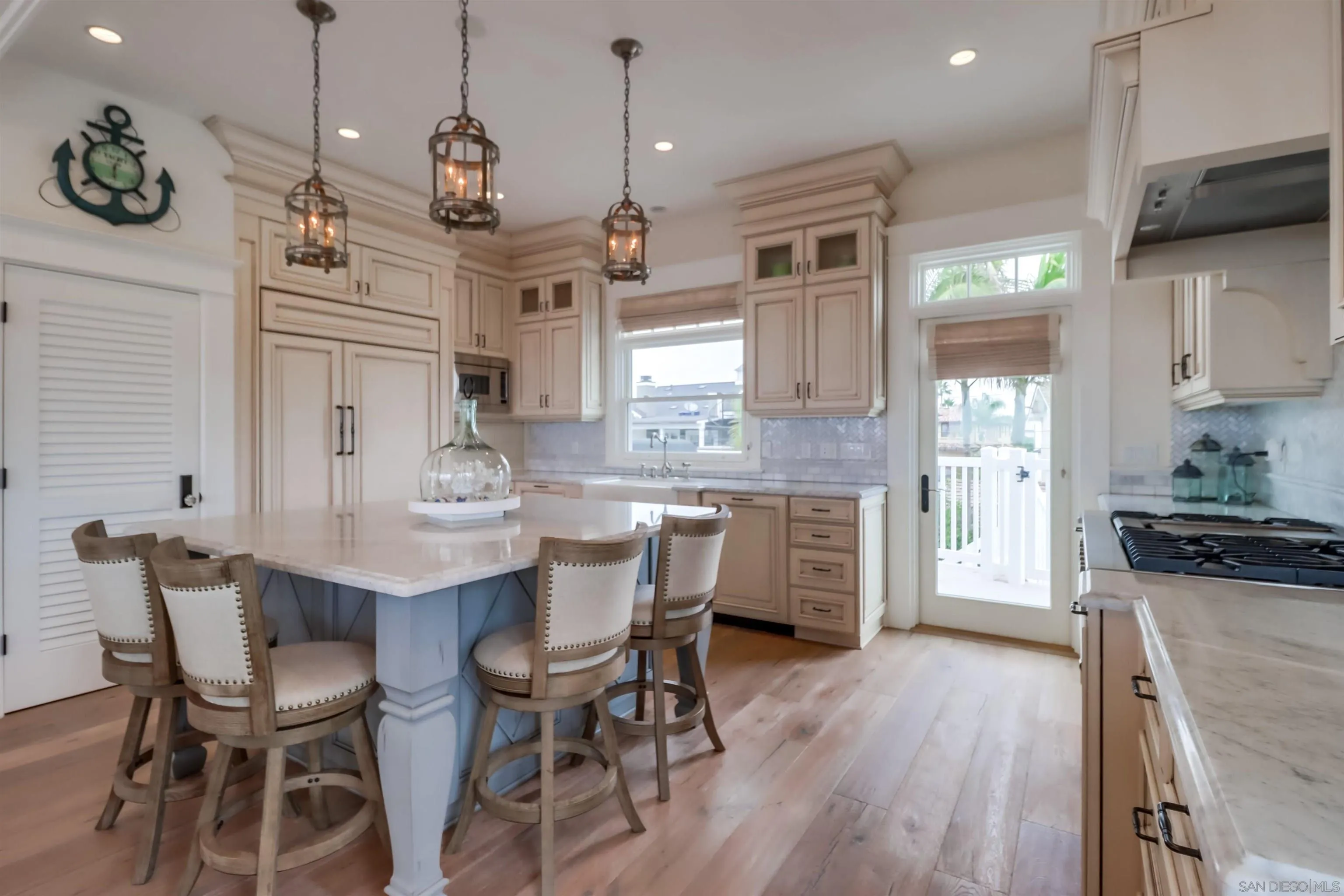 441 Ocean Boulevard Coronado, CA 92118 - Photo 8 of 40 a kitchen with stainless steel appliances kitchen island granite countertop a kitchen island hardwood floor and a sink