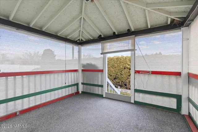 a view of a backyard with plants and a garden