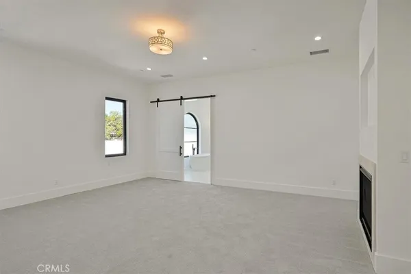 an empty room with windows and closet