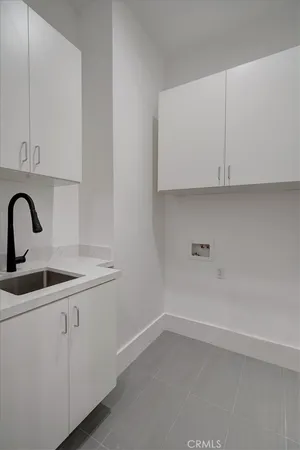a view of a kitchen with white cabinets
