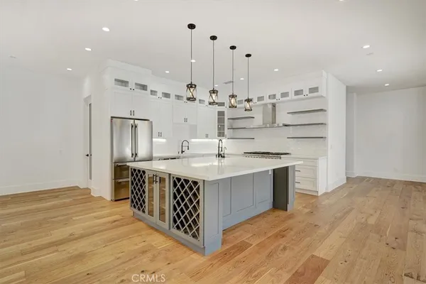 a kitchen with stainless steel appliances a stove and cabinets