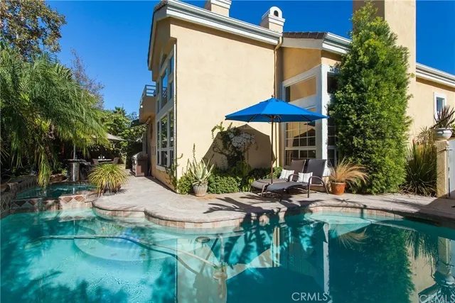 a view of backyard of house with seating space