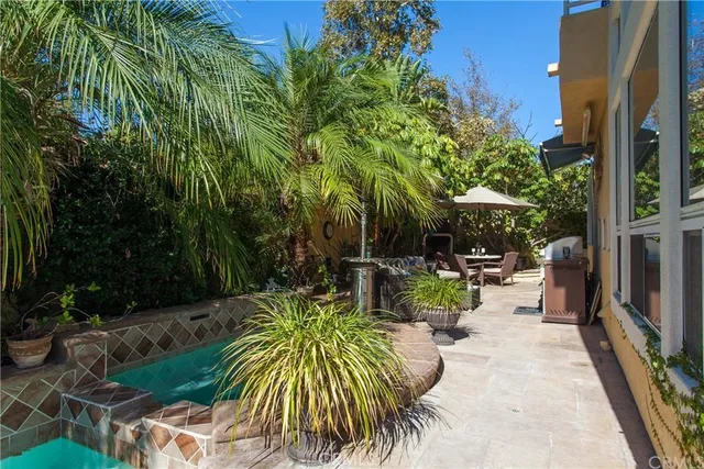 a view of backyard with outdoor seating and plants