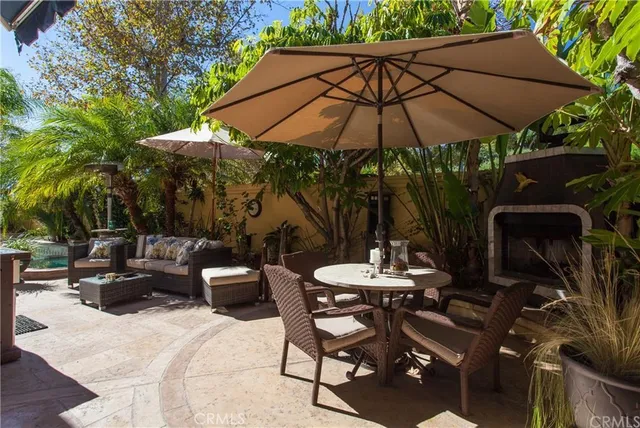 a patio with a patio table and chairs under an umbrella
