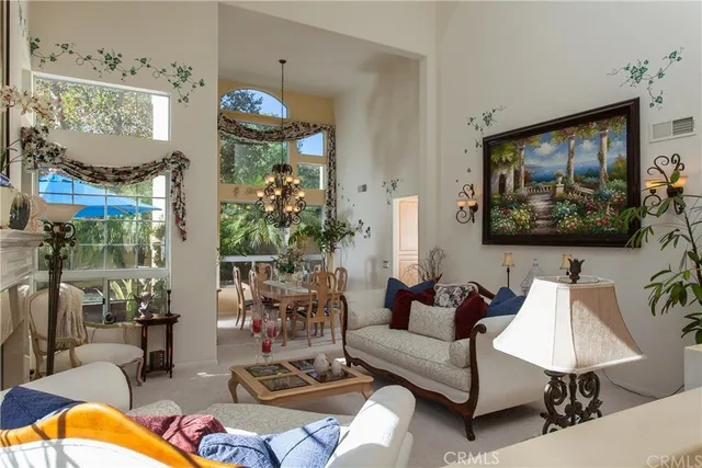 a living room with patio furniture and a chandelier