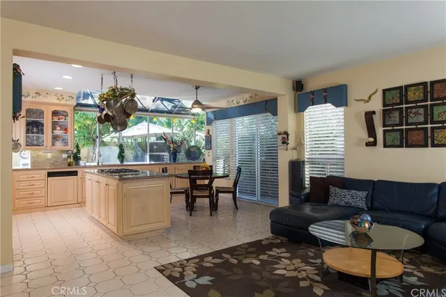 a living room with furniture and a dining table
