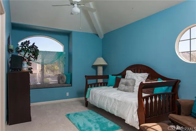 a bedroom with a bed and a mirror