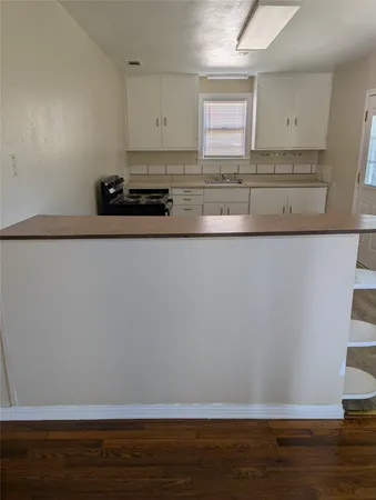 a view of cabinets and wooden floor