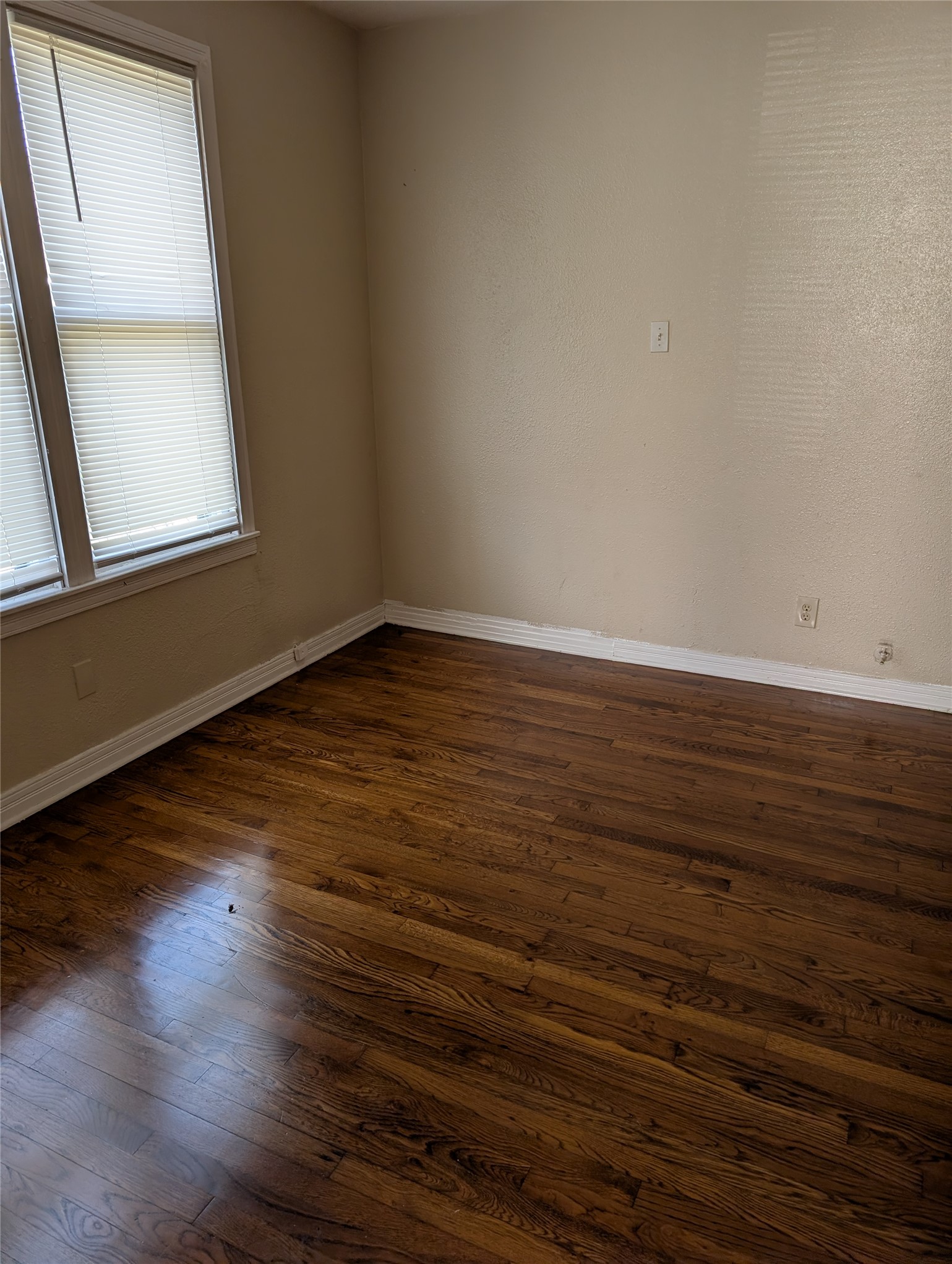 724 West 8th Street Taylor, TX 76574 - Photo 6 of 7 a view of a room with wooden floor and window