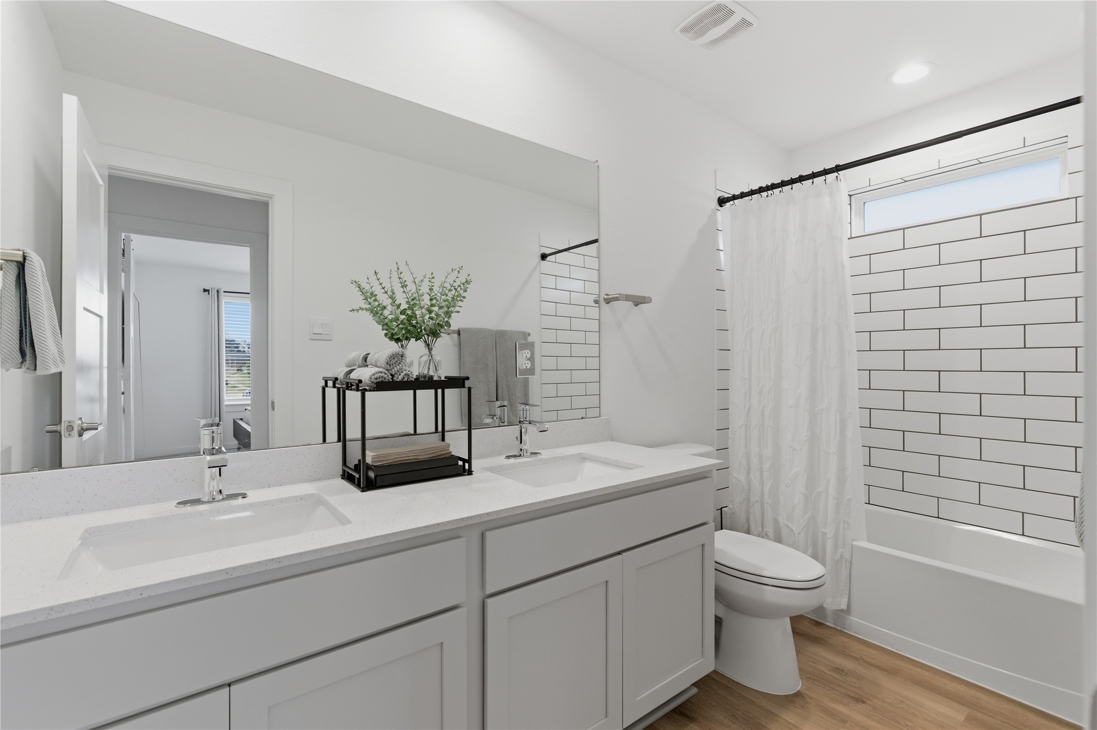 14108 Redfish Lake Conroe, TX 77384 - Photo 26 of 37 a bathroom with a double vanity sink toilet and shower