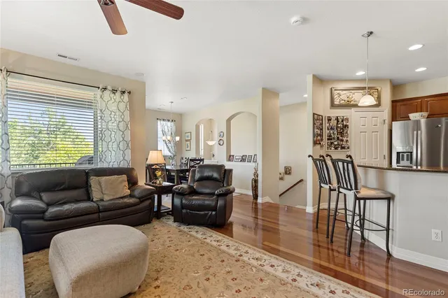 a living room with furniture wooden floor and a large window