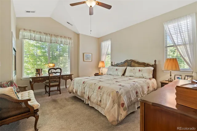 a bedroom with a bed and a large window