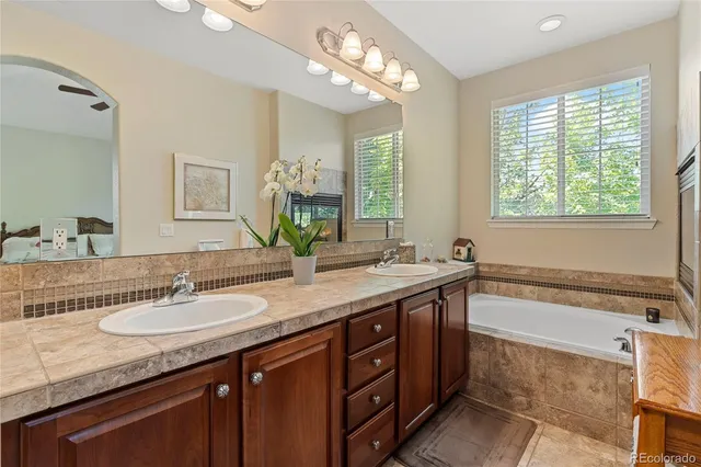 a bathroom with a granite countertop sink and a large mirror