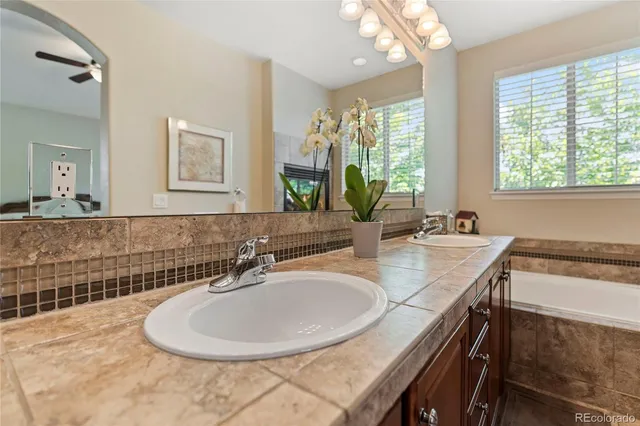 a bathroom with a granite countertop sink a mirror and a window