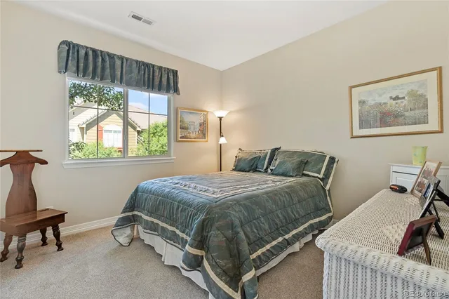 a bed sitting in a bedroom next to a window