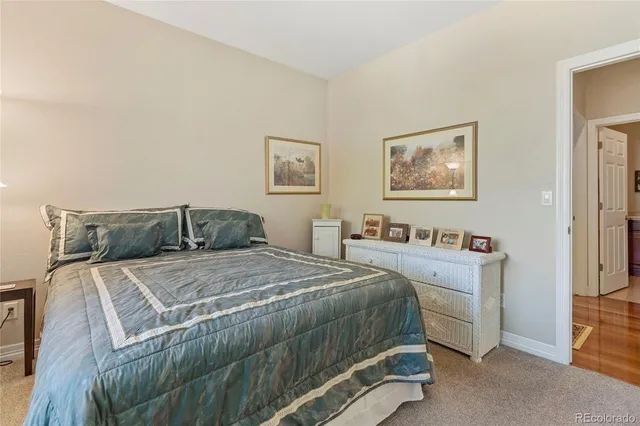 a bedroom with a bed and wall painting