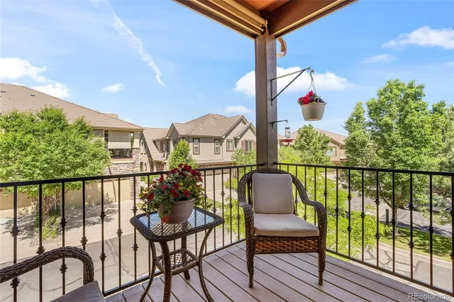 a view of a chairs and table in the balcony