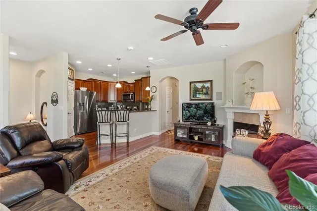 a living room with furniture a fireplace and a chandelier